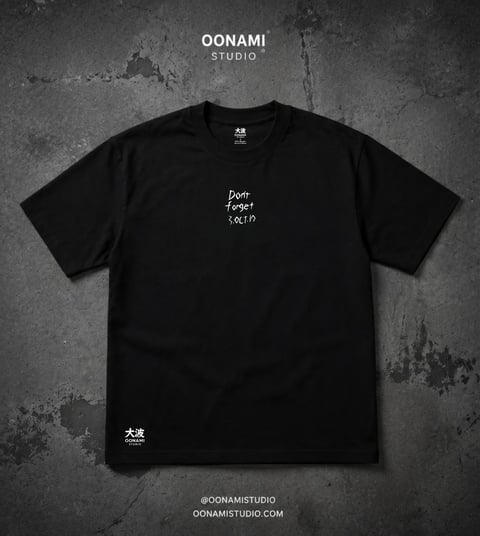 Black t-shirt from Oonami Studio featuring handwritten text on chest, displayed on textured gray background
