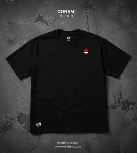 Black t-shirt with small red circular logo on chest against gray textured background, OONAMI Studio branding