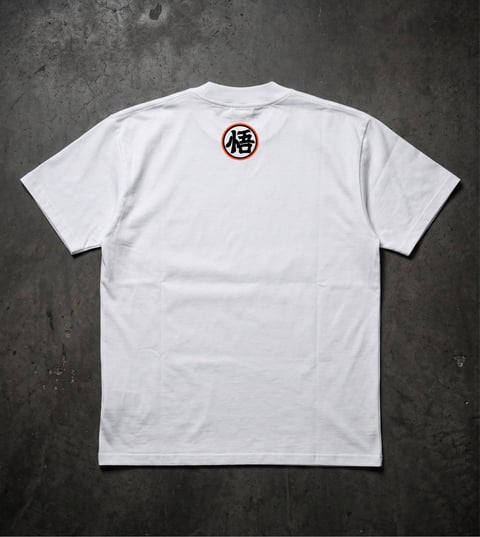 White t-shirt with Japanese kanji character in red circle emblem on back, displayed on dark textured background