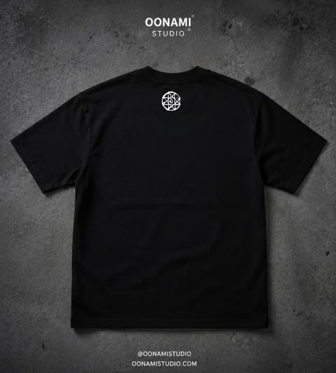 Black OONAMI Studio t-shirt with small circular logo on back, displayed flat on textured gray background